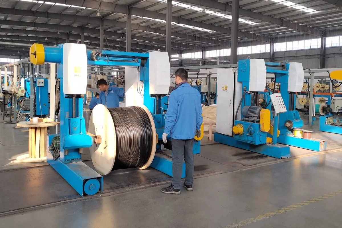 Aerial fiber optic cable production workshop with cable drum and manufacturing equipment