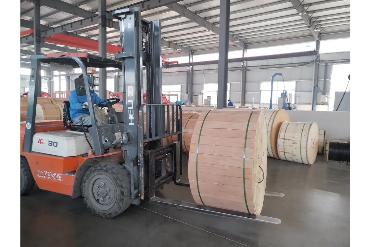 Fiber optic cable drums being handled in a production facility