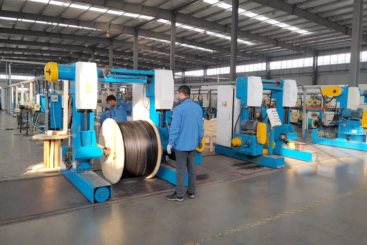 Fiber optic cable production workshop with cable drum and manufacturing equipment