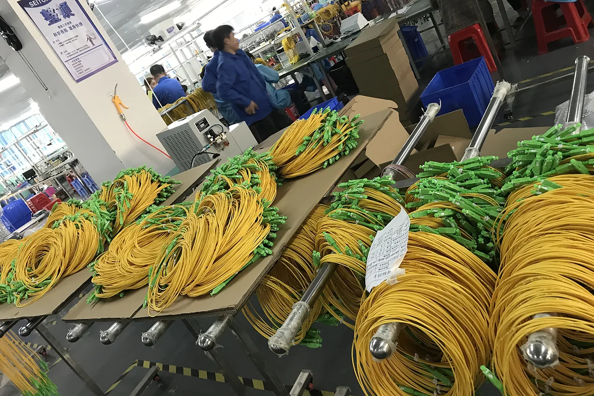 Finished fiber optic patch cord batches in a factory before inspection and packing