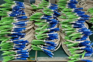 Fiber optic patch cords with blue and green connector housings prepared in a factory